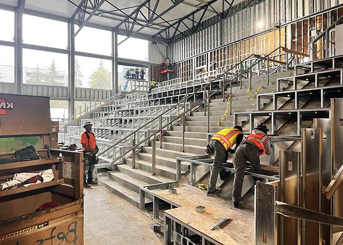 people are working on deep stairs in a room under construction